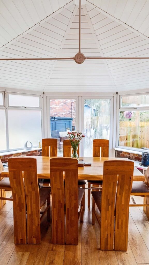 conservatory with dining room table in with conservatory insulation installed